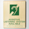 Eco-friendly ADA braille wood sign using 3D printing that says “assistive listening system available"