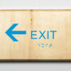ADA compliant wooden sign with 3d printing showing exit the left