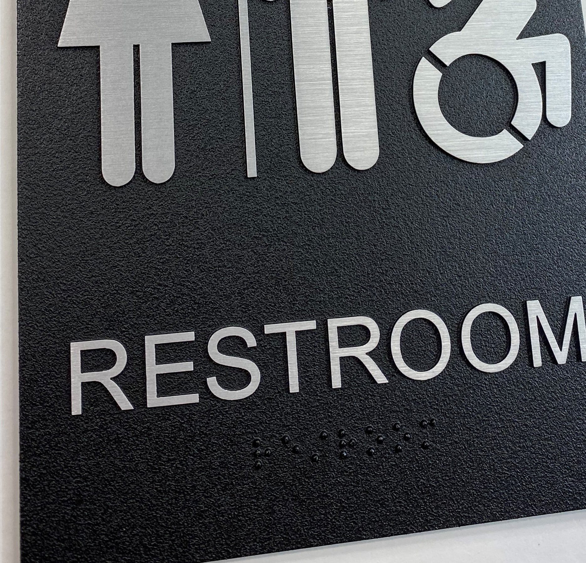 exterior all gender restroom sign, braille close up